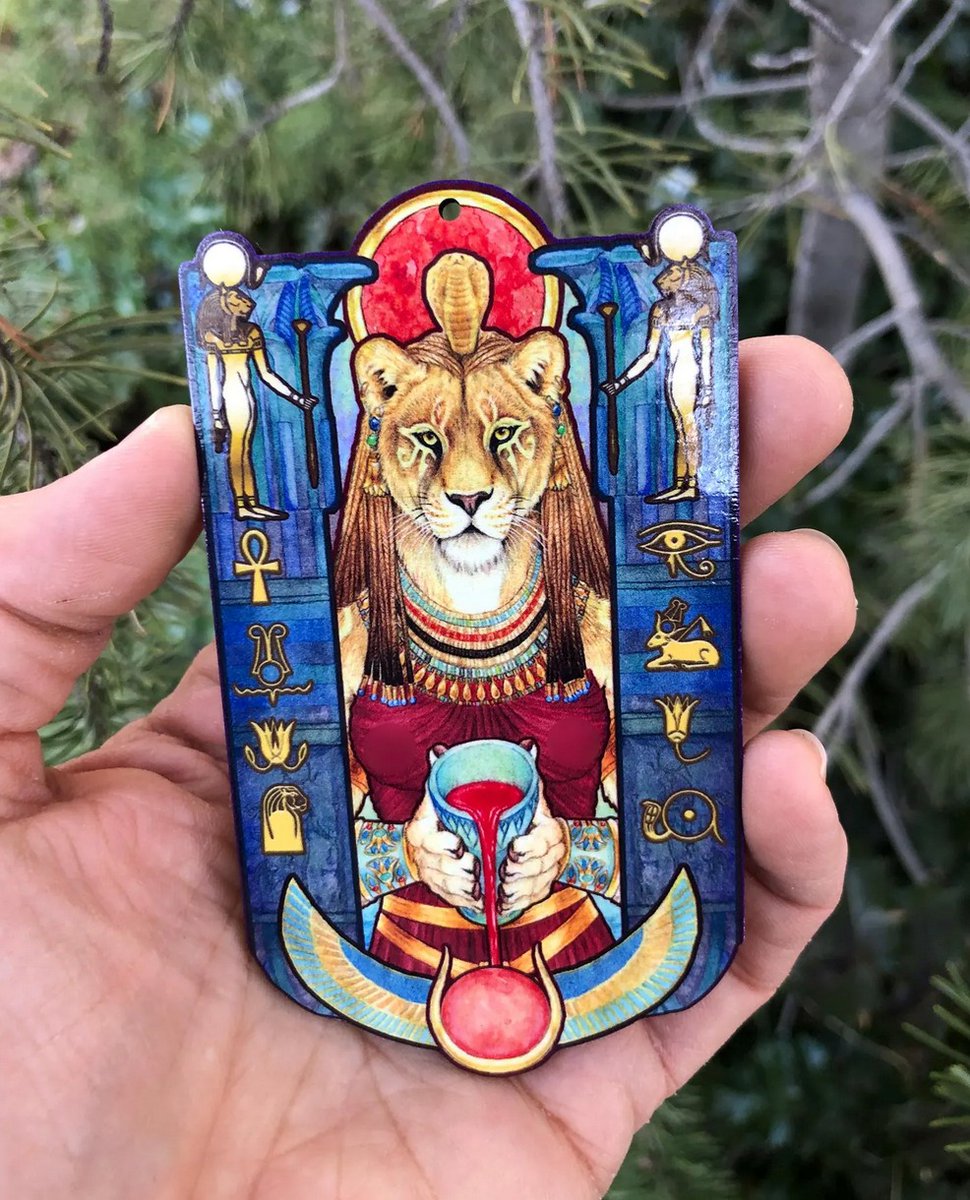 Speaking of my favorite Egyptian goddess, this #Sekhmet wooden talisman is perfect for your altar, wall, holiday tree, or even an as on oversized amulet. 
📿🦁
Printed on 4 X 2.5 inch eco-friendly cherry wood.

#egyptiangoddess #lioness #lion #kemeticpaganism