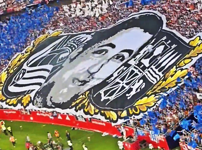 UltrasPresent's tweet photo. Tifo de Bultzada con los colores de su club 🔵⚪️ con el año que se fundó 1909 y la bandera del País Vasco 🔴🟢⚪️

Y abajo la cara de Aitor Zabaleta y a los lados el escudo de la Real Sociedad y el escudo de Euskal Herria.

Atlético de Madrid - Real Sociedad.
#CopaDelRey https://t.co/LDnurW4RJD