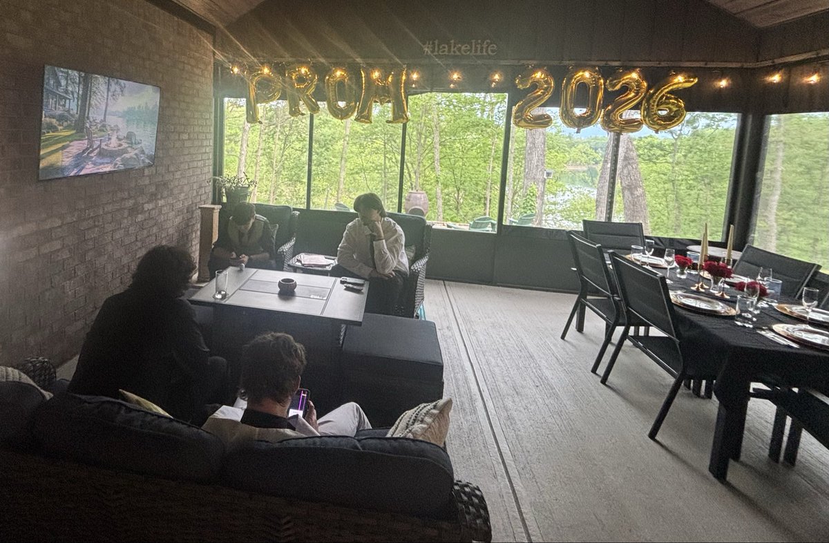 DavidMullinsDVM's tweet photo. 2026: A group of teenagers sitting 15 yards from a lakeside fire pit. 

With a video of a lakeside fire pit on the TV. 

All looking at their phones. (Probably scrolling AI generated  lakeside fire pits). https://t.co/gI9MditRZq