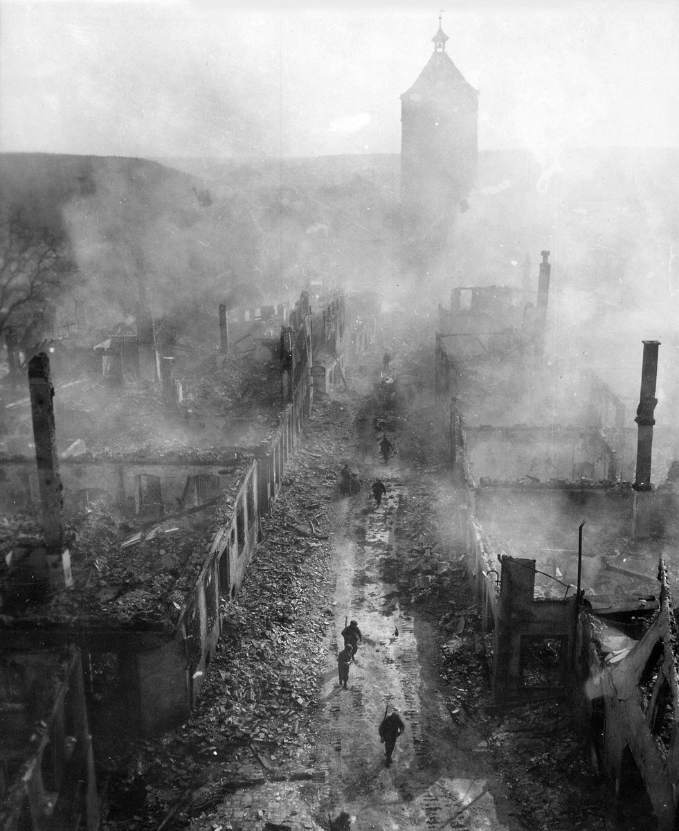 WW2Facts's tweet image. Infantrymen of the 255th Infantry Regiment move down a street in Waldenburg, Germany, on April 16, 1945.

#History #WWII