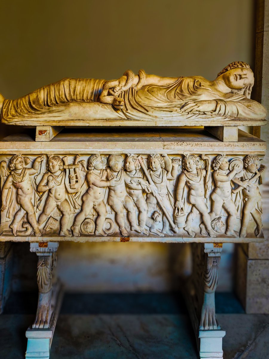 antmoose's tweet photo. Tonight's #SarcophagusSaturday from the #VaticanMuseums offers us two separate pieces: an extraordinary #lid with a reclining woman whose arm is wrapped round with a #snake, and a child's #sarcophagus with a parade of #Erotes imitating a #Dionysiac #thiasos. https://t.co/YiF94vsWC4