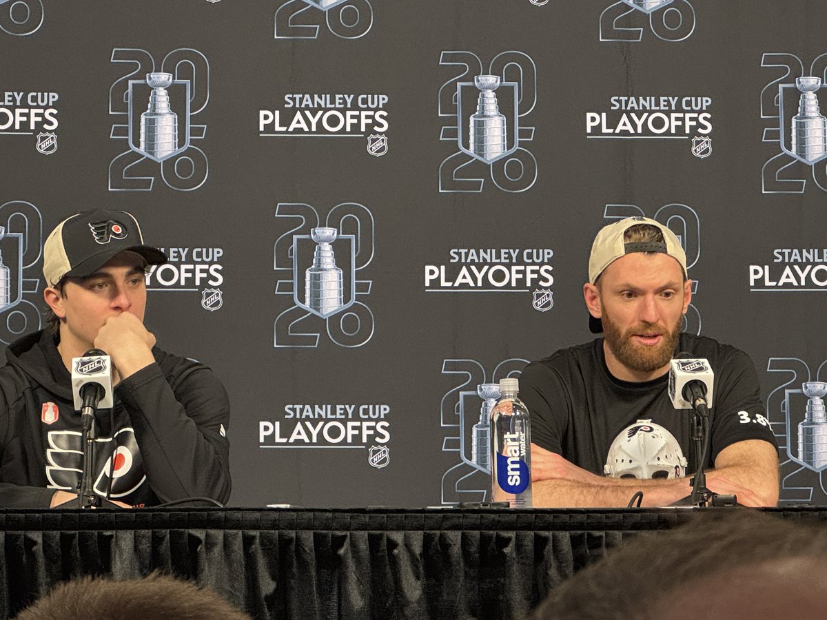 jackiespiegel93's tweet image. #Flyers forwards Porter Martone and Sean Couturier speaking at the podium. Couturier is wearing the t-shirt with the Bernie mask and 3.8% on the sleeve.