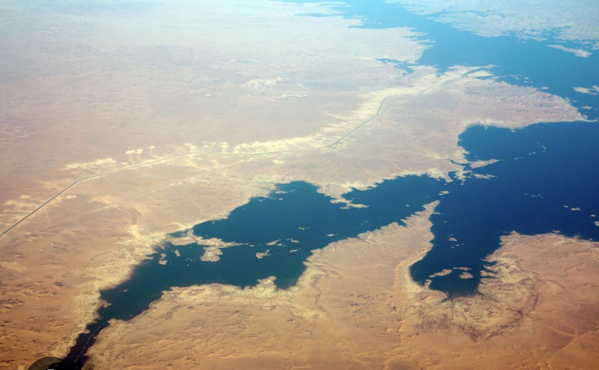 RenaissanceDam's tweet photo. Lake Nasser quick level-to-storage check, usable baseline, weak sediment correction

If someone wants a fast first-pass way to translate small Lake Nasser level changes into storage change, the baseline linear approximation is acceptable. Using the ILEC / WLDB active-storage line of 90.7 km³ across the 147 to 174 m band gives a slope of about 3.3593 km³ per 1.0 m, or about 335.93 million m³ per 0.1 m. That means a move from 174.0 m to 174.3 m implies about 1,007.78 million m³ in the baseline approximation.

That is the strong part of the table.

The methodological weakness begins when sediment scenarios are presented as if they were corrected Lake Nasser storage values. The widely cited 5.876 km³ figure refers to sediment accumulation in Lake Nubia, the Sudanese reach, not cleanly to Lake Nasser itself. The companion estimate for Lake Nasser is much smaller, about 1.194 km³ to 2012. So using 5.876 km³ as if it were a verified Lake Nasser sediment correction is not technically defensible.

The second problem is structural. A flat percentage reduction of the whole stage-storage slope is only a scenario assumption. It is not a demonstrated corrected dV/dh relation. Without an updated post-sedimentation stage-storage curve, those adjusted columns should be treated only as rough brackets, not as corrected Lake Nasser storage conversions.

There is also a measurement caution. One whole-lake validation reported satellite-altimetry RMSE around 0.62 to 0.72 m against in-situ levels, although some smaller-area studies reported lower errors. That means small level changes, especially below about half a meter, should not be overinterpreted unless the exact data source, processing method, and uncertainty treatment are stated clearly.

So the only defensible reading is narrow and limited. The baseline column is useful as a rough screening tool. The sediment-adjusted columns are scenario brackets, not verified Lake Nasser corrections. And the table is not strong enough to support confident headlines about corrected live storage unless a real updated hypsometry is provided.

#LakeNasser #AswanHighDam #Nile #Hydrology #WaterBalance #RemoteSensing #Sedimentation #DamEngineering #Egypt