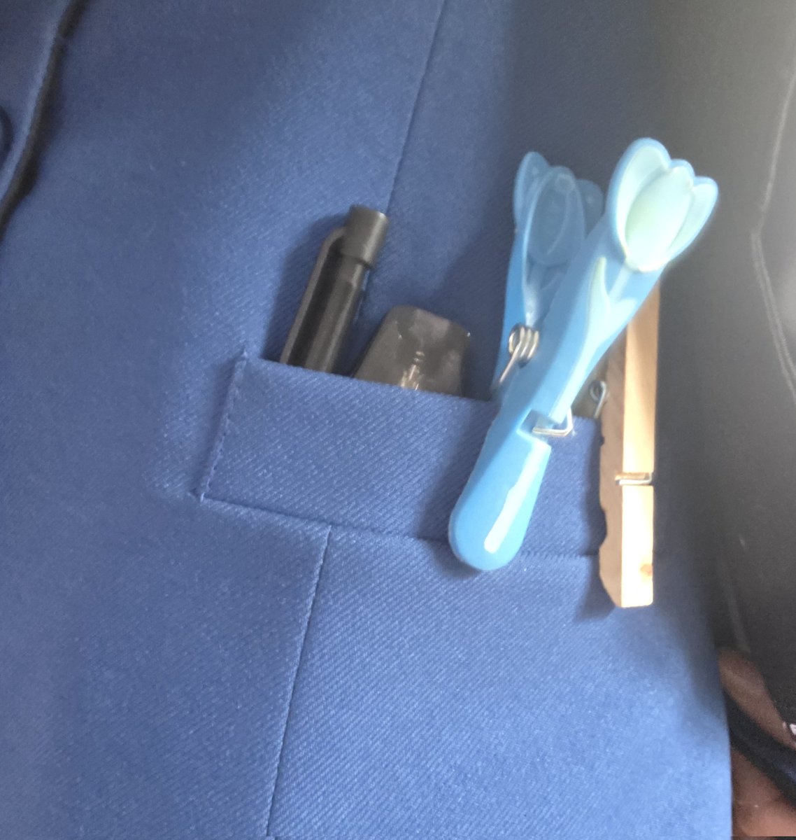 the pockets of a band master. pegs, pencil, and a vape. its all one needs in life