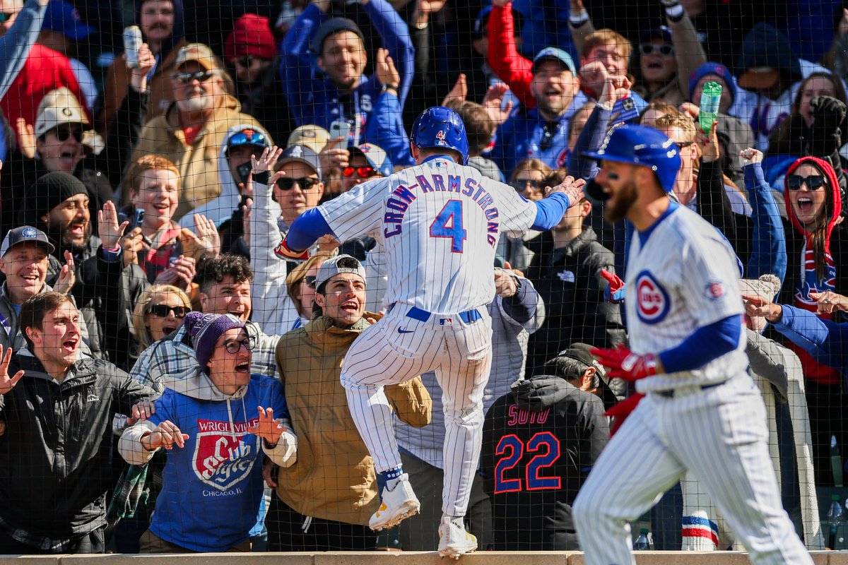Cubs center fielder Pete Crow-Armstrong jumps on a ledge to celebrate with fans after scoring off Nico Hoerner’s walk-off sacrifice fly in the tenth inning to give the Cubs a, 2-1, win over the Mets at Wrigley Field Sunday in Chicago.