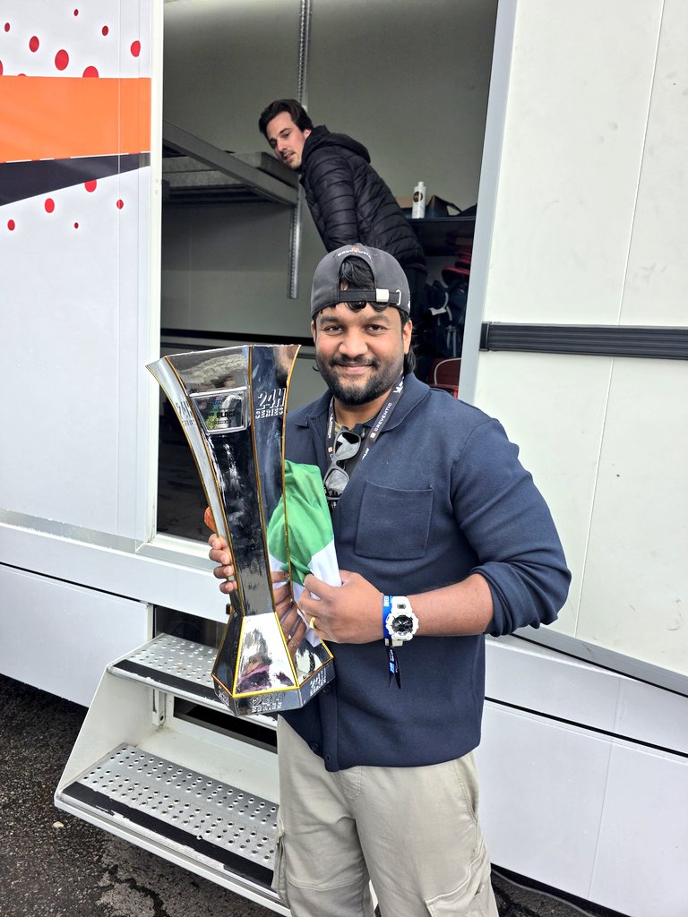 nobody_offl's tweet image. AK sir gave me the trophy and flag and said, "Set it up near the trailer to take photos with fans." I was cheeky and took a photo myself first. 🤪🤪 #AjithkumarRacing