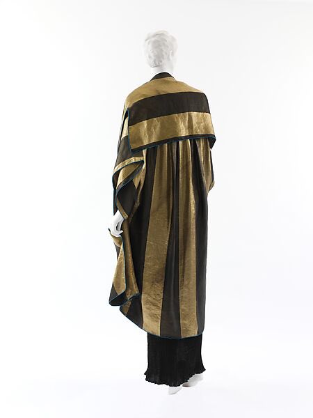 Paul Poiret was born on this day in 1879. He would become a genius of dress construction, the example here one of origami-like structure. The gold lamé shawl style coat is called Pré Catalan after a fashionable eatery in the Bois de Boulogne, 1918 <a href="/metmuseum/">The Metropolitan Museum of Art</a> #fashionhistory