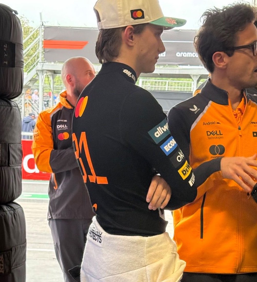 Oscar Piastri's habits pouting resting his hand on his thigh, and standing while hugging himself