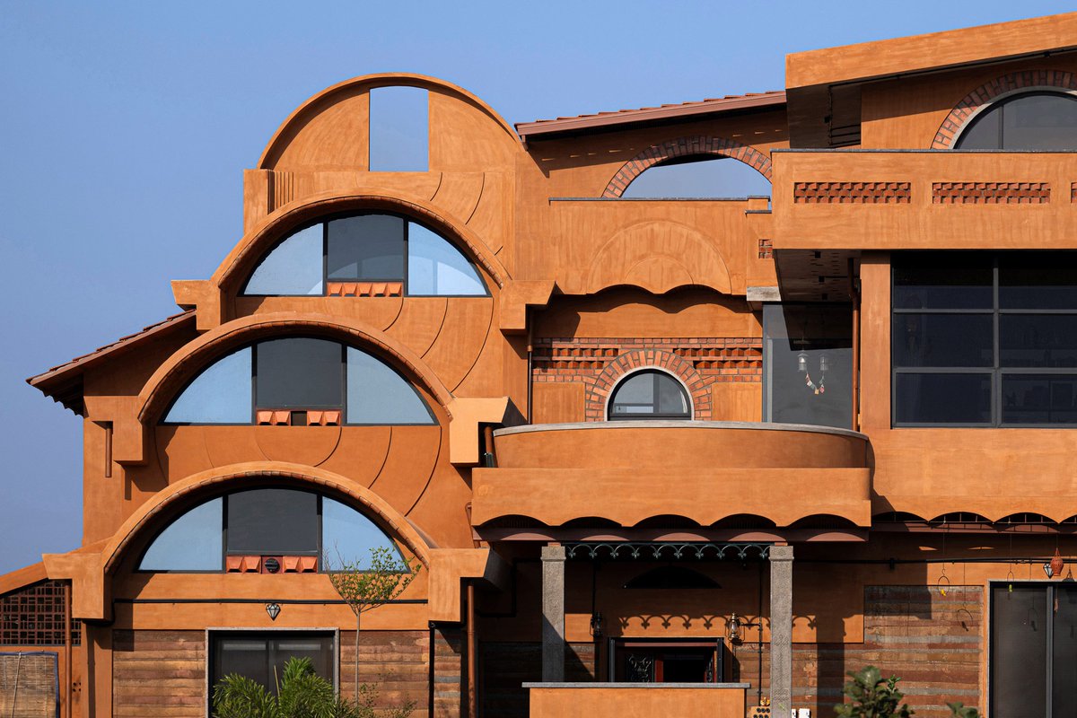 IKI's Aurva Illam in India merges traditional spatial layouts with modern, sustainable design to create a breathing sanctuary. The project utilizes a perforated brick skin and internal courtyards to optimize passive cooling and privacy