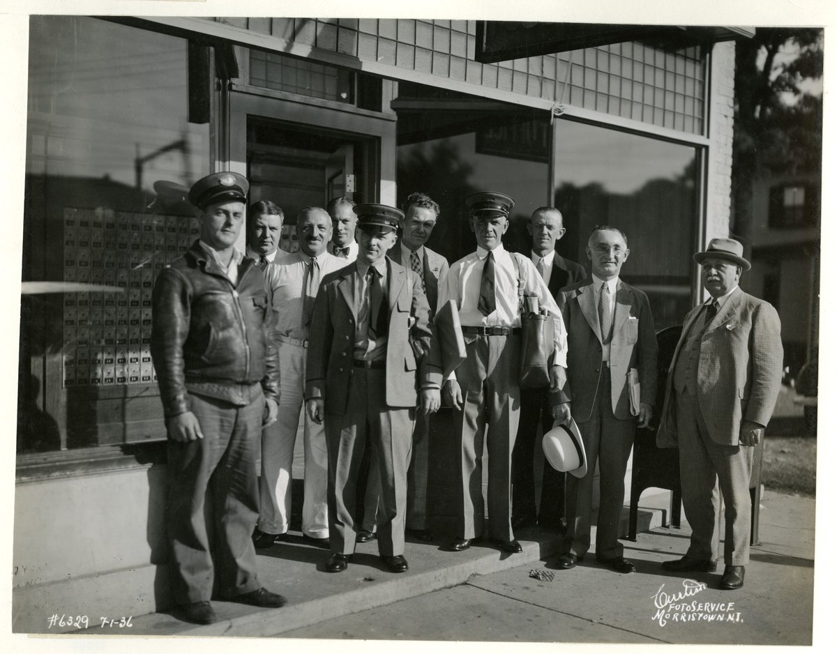 NJHistoryCenter's tweet photo. As the boro of Morris Plains turns 100 this month we've been sharing images from our photo collections. Among the workers who helped build &amp; keep the town running were these two rail depot drivers, the proprietors of D.M. Merchant's Hardware Store, and a group of postal workers https://t.co/FMAFKyhZpU