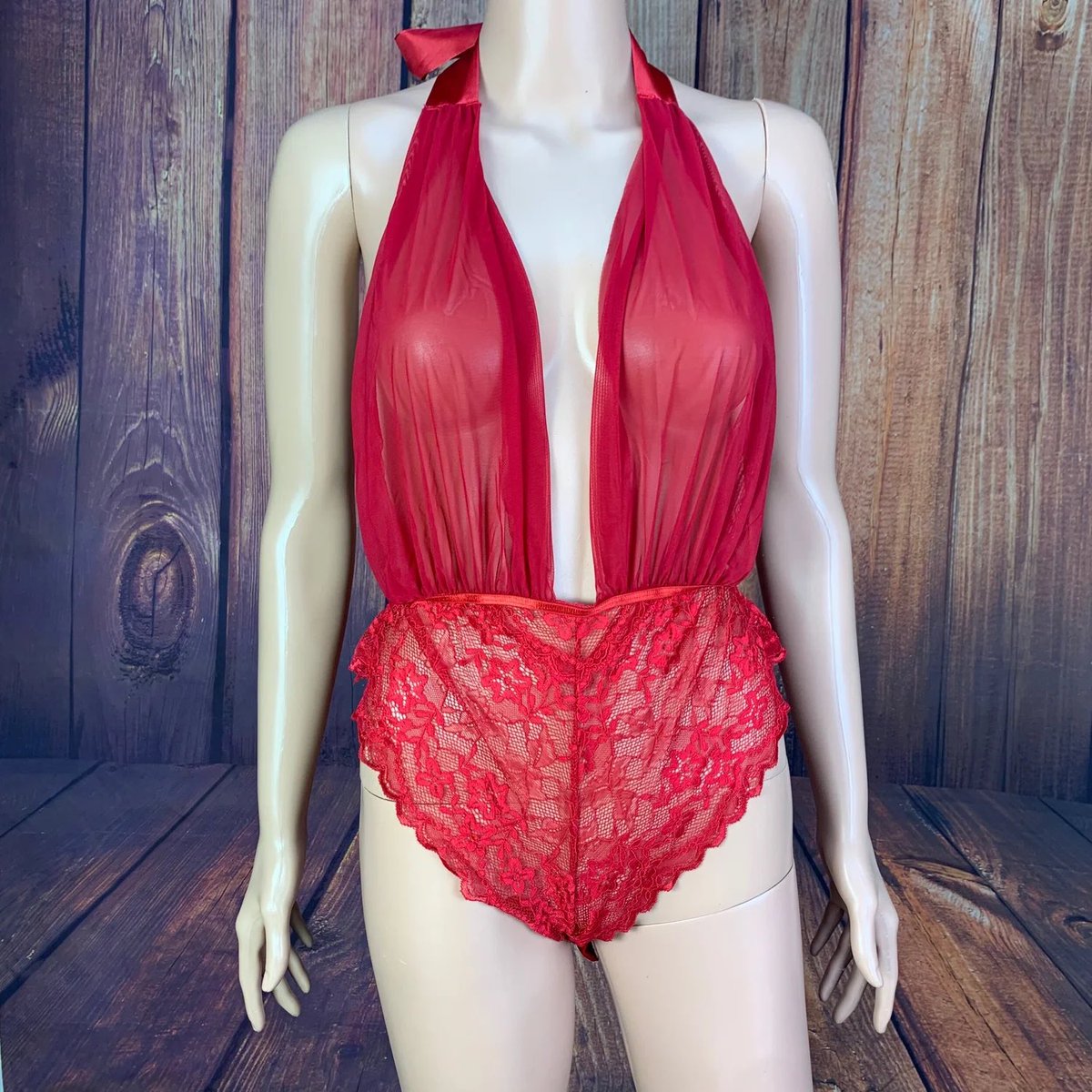 Red Sheer Halter Teddy 👄This lovely, red teddy features a sheer, adjustable halter top with ribbon tie, and stretchy lace cheeky bottom with snap-crotch.