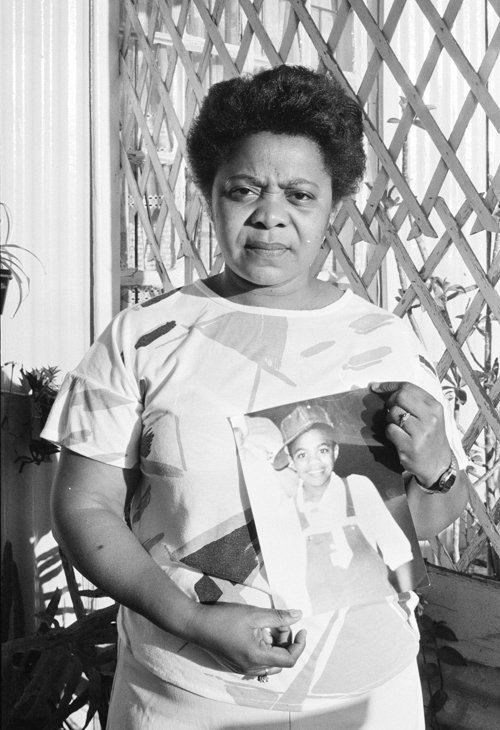 A mother holds a photograph of her slain child, Shaun Magmoed, who was killed in an incident known as the 'Trojan Horse massacre' when three young boys were shot and killed by security forces during a student protest in Athlone, Cape Town. Credit: Zubeida Vallie/UCT Photography