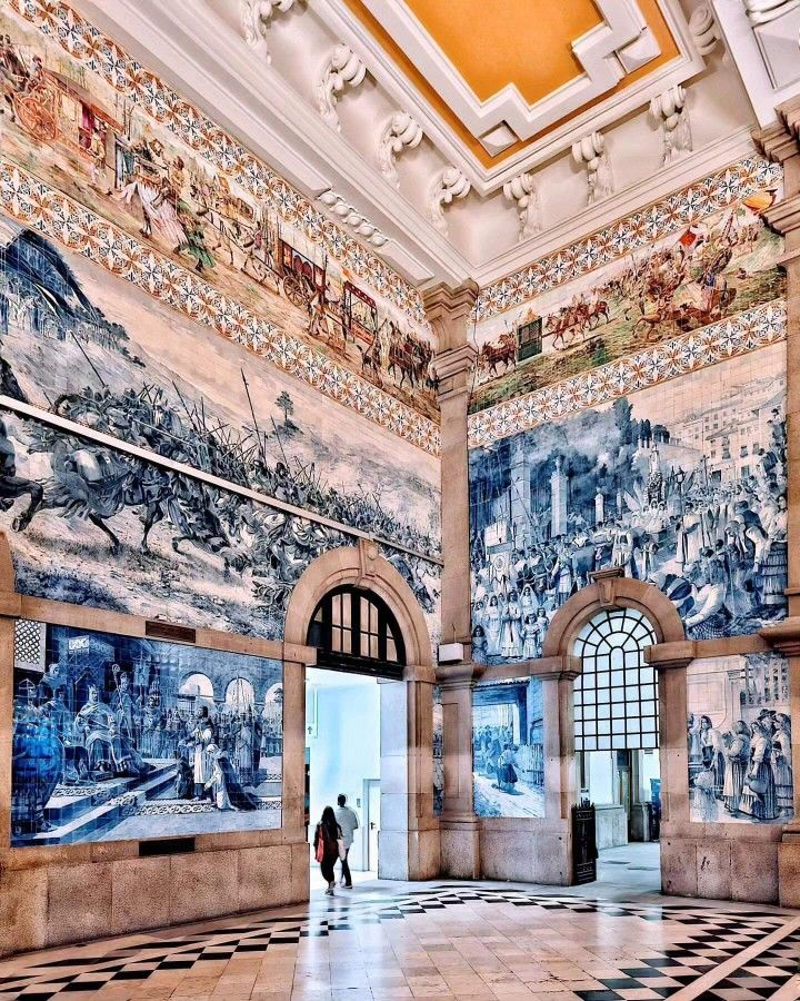 The main hall of the São Bento Railway Station in Porto, Portugal, famous for its elaborate tile work.
