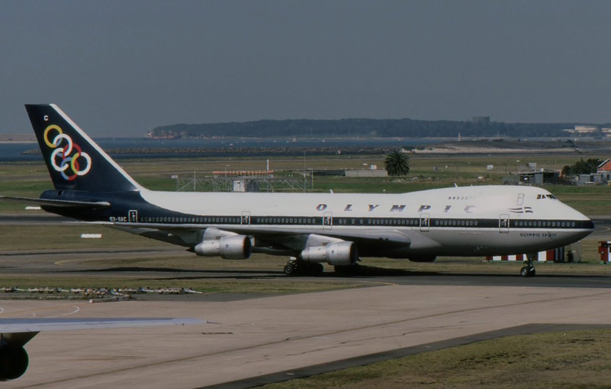 n194at's tweet image. Olympic Airways 
Boeing 747-212B SX-OAC
SYD/YSSY Sydney Kingsford Smith Airport
September 1987
Photo credit David Carter 
#AvGeek #Airline #Aviation #AvGeeks #Boeing #B747 #QueenOfTheSkies #SYD #Sydney #Olympic