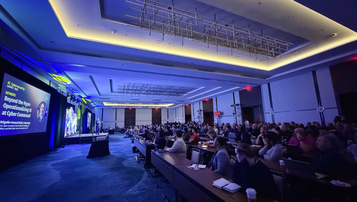 SANSInstitute's tweet image. Brigadier General Reid J. Novotny is at the podium at #AISummit and diving into how AI is shaping real-world cyber operations.

Register for Free &amp;amp; Join Online: sans.org/u/1CNB

#AISecurity #CyberSecurity #AI #ThreatIntelligence #Infosec