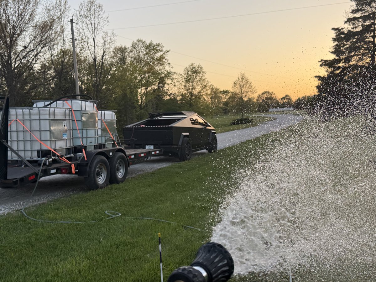 DeBergo's tweet photo. Making my Cybertruck earn its keep. Pulls my water rig and powers it to water our tree and Miscanthus grass farm https://t.co/MBbGgKz75k