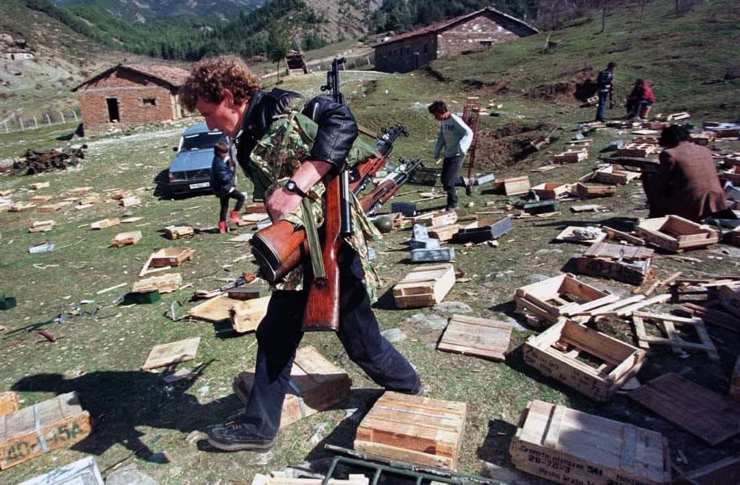 Albanian man carrying multiple rifles, Albania, 1997.🇦🇱
