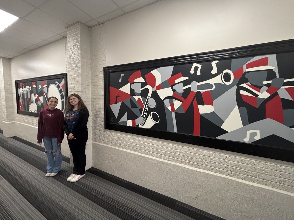 usd358's tweet photo. Aubrey Justice and Cecily Shull, senior art students, have finally completed the new murals in the band hallway. We are so proud of these young ladies' hard work and dedication to their artistic endeavors. https://t.co/LPmFPsit81