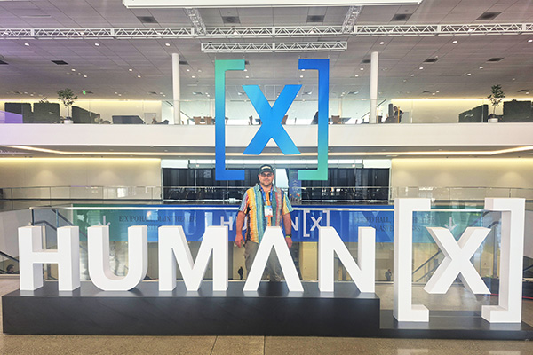 Moses_Silbiger's tweet photo. Just published a new article with @MaxRender on Human X 2026 @HumanXCo - one of the most interesting AI conferences I attended this year, alongside SXSW 2026.

One idea stood out across multiple sessions:
AI is evolving toward world models - systems that perceive, simulate, and interact with the world.

Across the event: 
Fei-Fei Li (world models) 
Ray Kurzweil (future of AI)
David Baszucki (Roblox) - interactivity
Andy Konwinski (Perplexity / Databricks) - infrastructure
Cameron Adams (Canva) - creative workflows
Jensen Huang (NVIDIA, remote/exclusive) - AI & accelerated computing

The shift toward world models and interactive systems connects with the Press Play to Grow! initiative (https://t.co/sxG4nd7mDn⁠) - exploring how AI, interactive entertainment, and ways to evaluate and promote development can catalyze diverse human potentials.

Article (Portuguese - translate in browser):
https://t.co/MsUq0N8ynk⁠�

Images: 
Moses Silbiger - on-site at HumanX 2026  
Ray Kurzweil - AI futures & long-term trajectories  
Jensen Huang — AI & accelerated computing (remote)
Neal Stephenson — author of Snow Crash & coiner of the term “metaverse” (with Moses Silbiger)