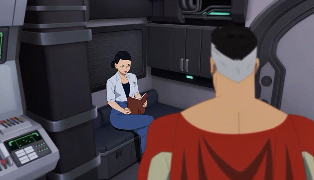 ( she's reading "the man with the invincible gun " novel . . )