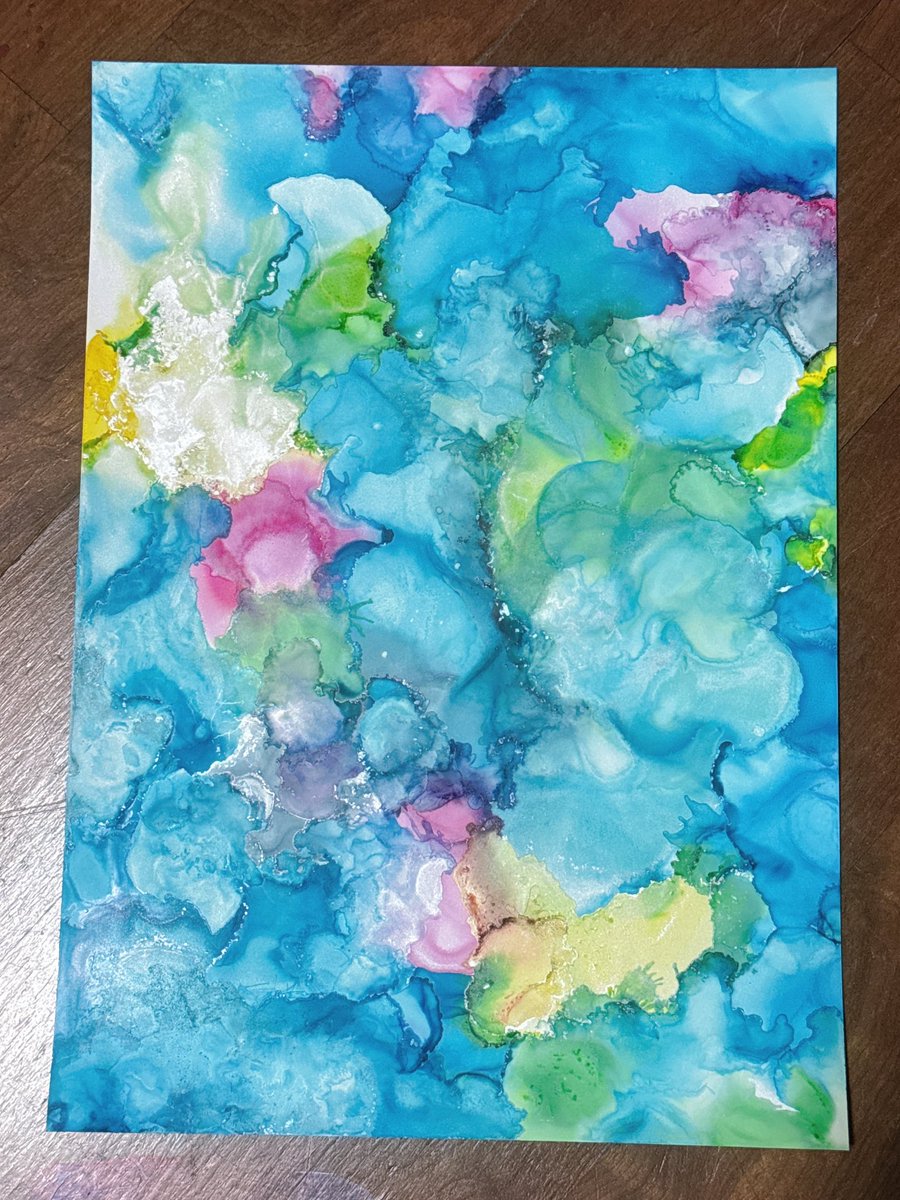 An alcohol ink painting inspired by the color palette of the triquetra.