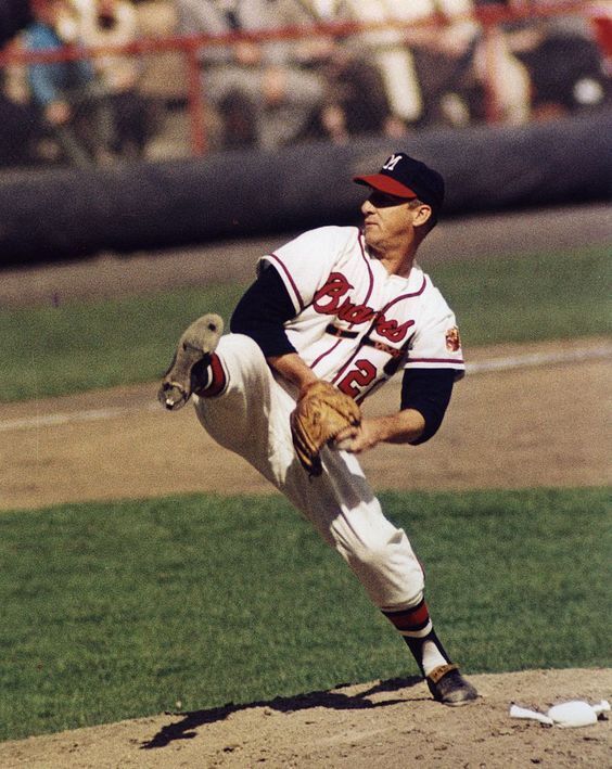 Warren Spahn delivering a pitch in County Stadium in 1957. Spahn was dominant in 1957, going 21-11 with a 2.69 ERA, 111 strikeouts, and leading the National League with 18 complete games. as he won the Cy Young Award