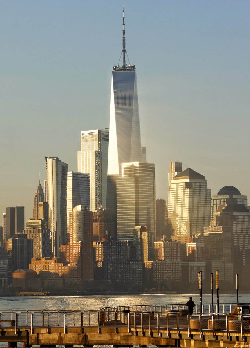 GaryHershorn's tweet image. The sun reflects off One World Trade Center as it rises in New York City, Thursday morning, seen from Hoboken, NJ #newyorkcity #nyc #newyork #sunrise @_WTCOfficial