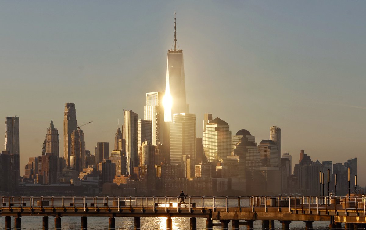 GaryHershorn's tweet image. The sun reflects off One World Trade Center as it rises in New York City, Thursday morning, seen from Hoboken, NJ #newyorkcity #nyc #newyork #sunrise @_WTCOfficial