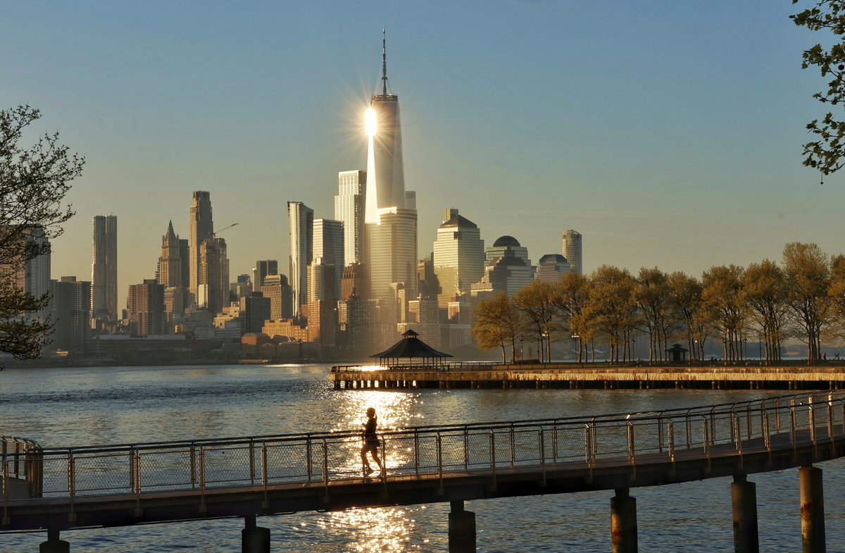 GaryHershorn's tweet image. The sun reflects off One World Trade Center as it rises in New York City, Thursday morning, seen from Hoboken, NJ #newyorkcity #nyc #newyork #sunrise @_WTCOfficial