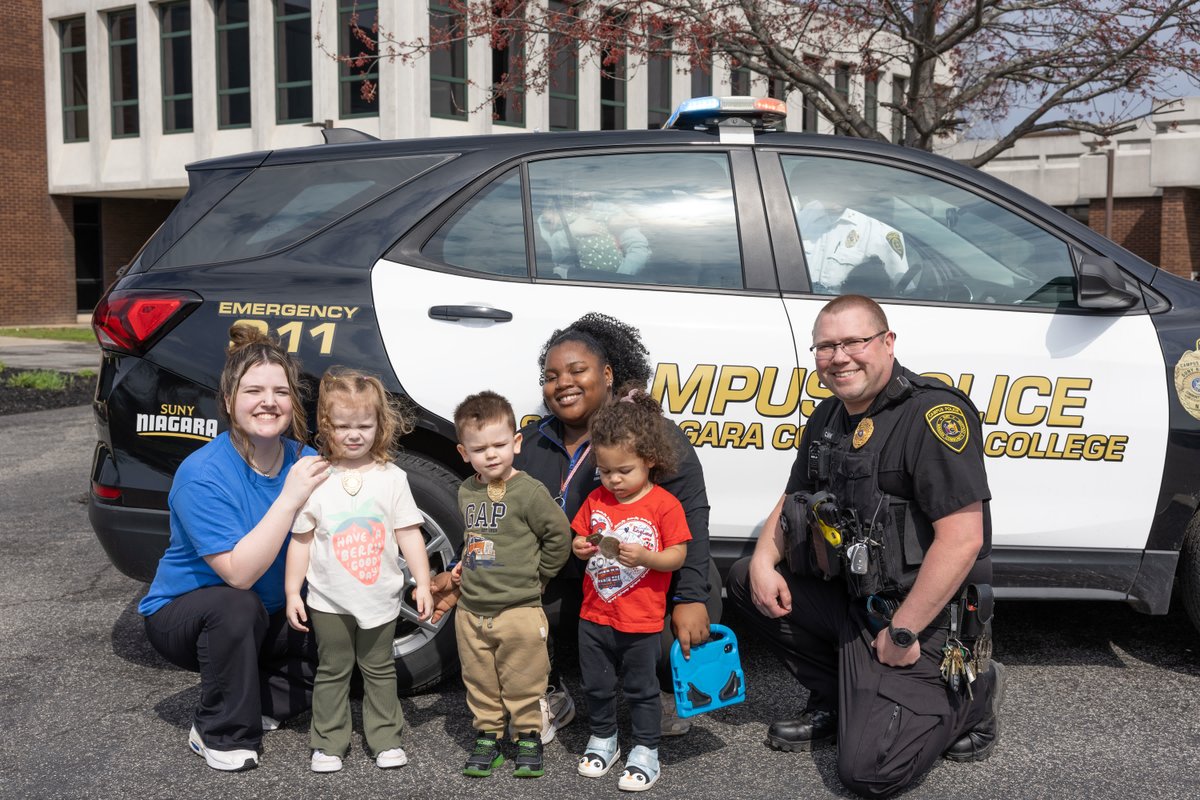 SUNYNiagara's tweet photo. Campus Safety read to our daycare students last week, teaching them the importance of things like listening to their parents to stay safe, and being cautious of strangers.

They even got their own badges, and had a chance to play in the car. 🚘📖⭐ https://t.co/zh0fHhq9ju