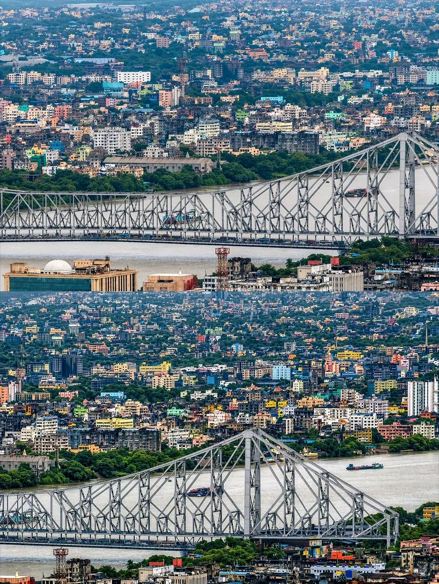 The cityscape of Howrah by the Hooghly river with the iconic Howrah ...