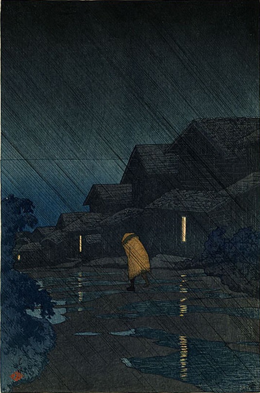 A rainy evening in Teradomari, just over 100 years ago ~ a huddled traveller braves the storm, as puddles reflect the warm lights of the village houses (Kawase Hasui, woodblock print, 1921)
