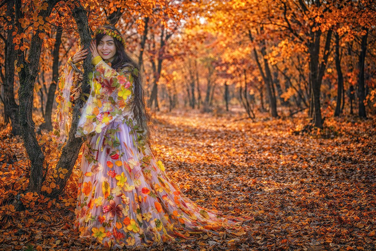 We handcrafted this dress using autumn and oak leaves to reflect the spirit  of the forest and fall. We named this photograph A Girl in the Embrace of  the Forest. 12 $xtz