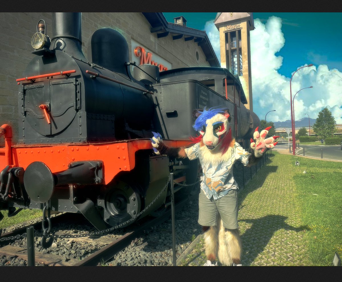 GarciGreen's tweet photo. For this #FursuitFriday we are in Haro, capital of wine, and this was the locomotove that transported the wine from this region to the rest or the country and Europe.

📷✍️: @KennethM_Cruz
🪡: @chibeasts

#Furry #FurryFandom #Clown #Genetta #Spain https://t.co/WEGl1lp0Cy