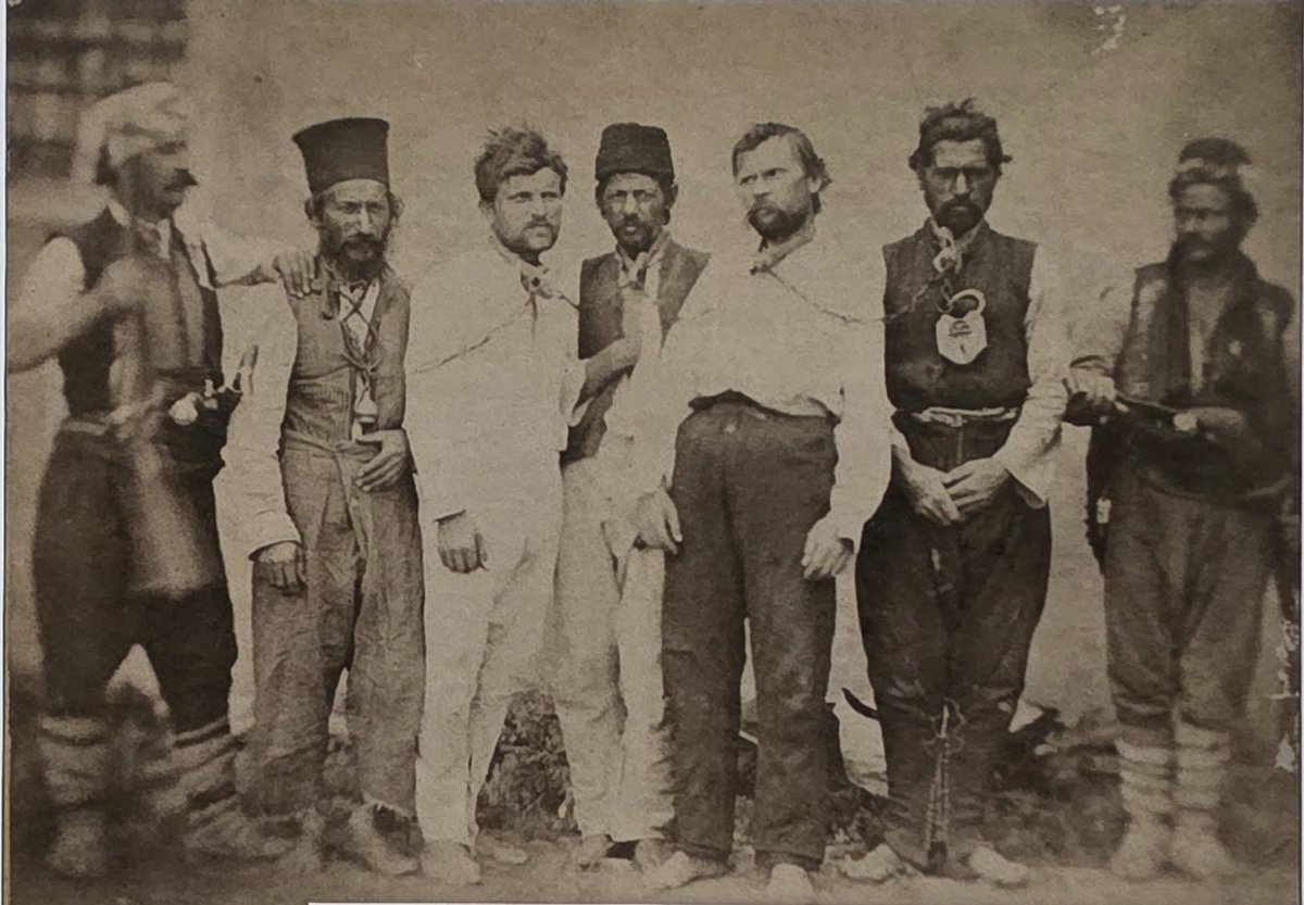 Ottoman bashibozuks posing with captured Bulgarian rebels, May 1876. On the left is legendary priest Gruyo, who led the rebellion in his home village of Banya, near Panagyuriste. He survived two Ottoman imprisonments in 1876 and 1877 and lived to see liberated Bulgaria.