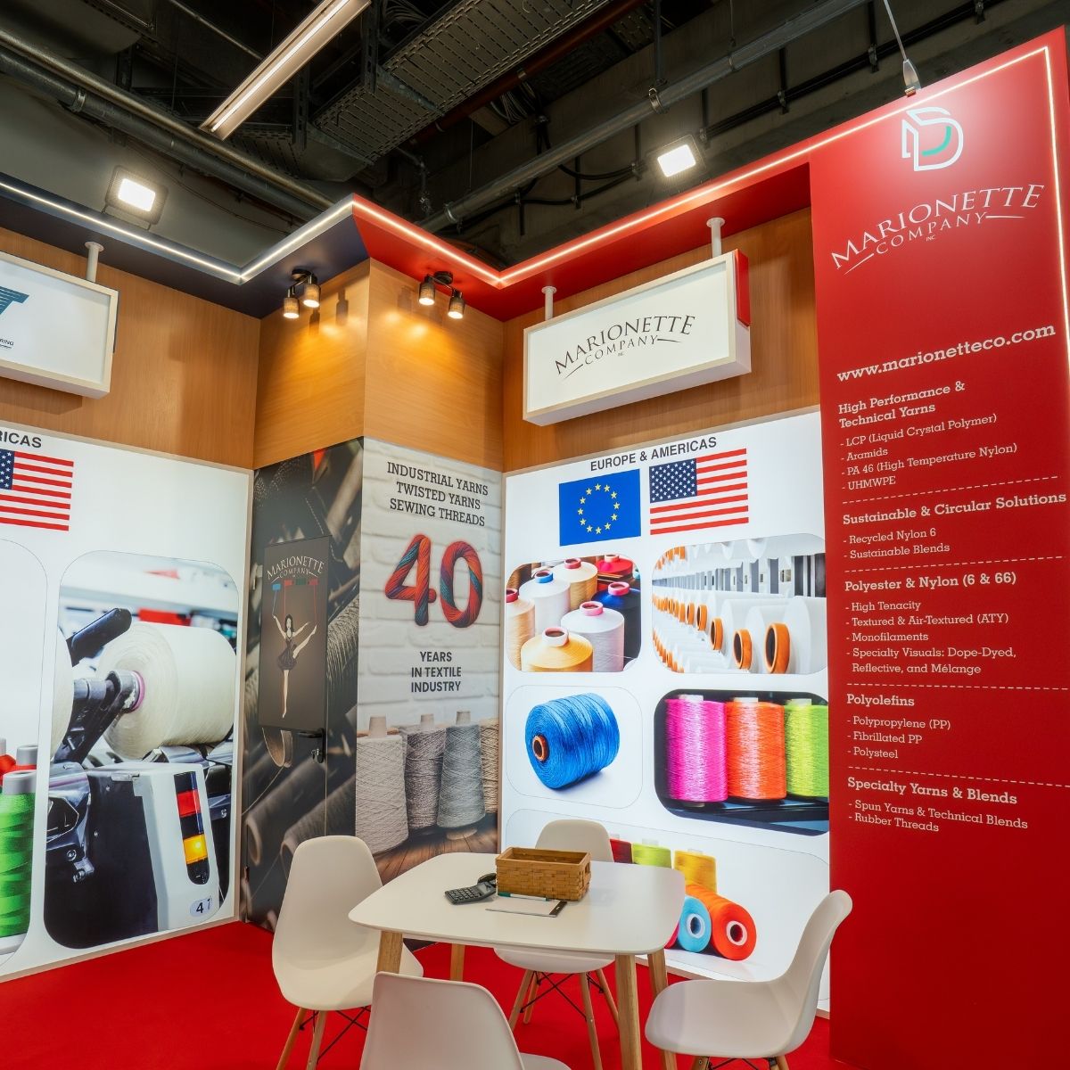 DesignDeskIndia's tweet photo. Live from Day 4 at Techtextil 2026, Germany 🇩🇪

We leaned into that direction with large backlit graphics to create strong visibility from a distance. The edge-lit platform adds a subtle glow at ground level, while the suspended brand signs help break the flatness of the space. https://t.co/uB1BAwuIgc