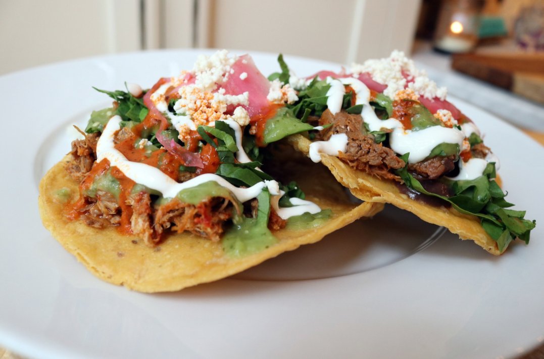 cincycinco's tweet photo. These tostadas look tasty! Try Mazunte's version with shredded pork with black bean purée and topped with avocado salsa,  crema y queso fresco. https://t.co/59FppUINgs