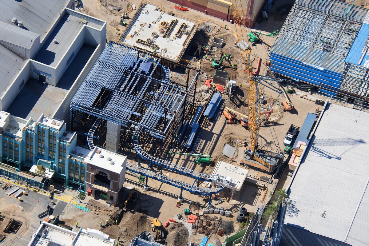 Aerial overview of construction at the station of Fast &amp; Furious Hollywood Drift. Track recently placed for the dual load/unload of the attraction.
Two concrete platforms are seen for switch track. The platform at top center was recently cast.
Ride service building at top right.