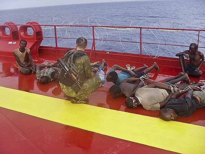 A Russian marine from the frigate 'Marshal Shaposhnikov' explains to Somali pirates that attacking a Russian tanker was a foolish idea, 2010.