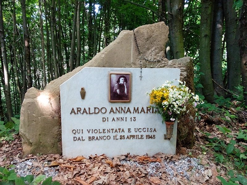 Anna Maria Araldo, 13 years old.
Stevagni, Frazione Croce, Castelnuovo di Ceva.

It is April 30, 1945. The war is over. A young girl is out walking her dog in the woods when the animal suddenly starts digging furiously. The little owner approaches and freezes in terror. Buried