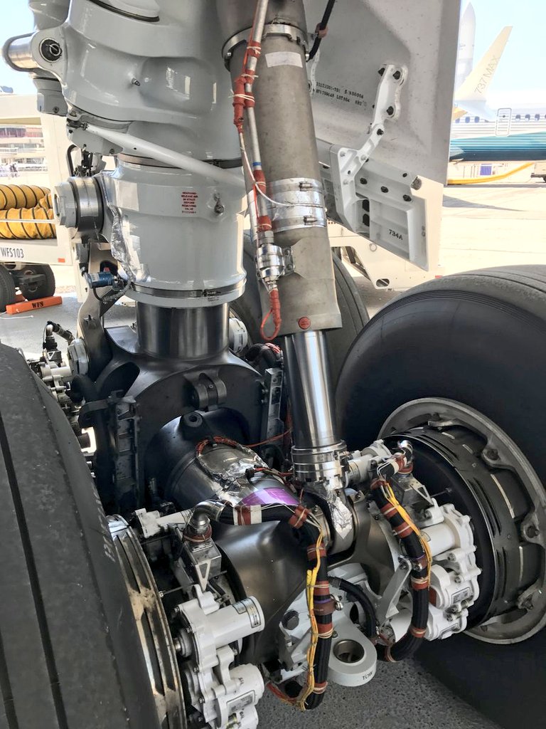 chainsawrocks's tweet photo. On the Boeing 787-8 and 787-9, all four wheels of each main landing gear remain in contact with the runway during the initial rotation. This limits the aircraft’s maximum nose-up pitch angle to 11.2° for the 787-8 and 9.7° for the 787-9 to avoid a tailstrike.

For the longer 787-10, Boeing introduced a hydraulic strut at the forward end of the main landing gear trucks. This strut restricts the amount the gear truck can tilt during rotation. As a result, the forward pair of wheels lifts off first, allowing the aircraft to pivot smoothly over the rear axle in a gentle “tiptoe” motion.

This modification increases tail clearance, enabling the 787-10 to achieve the same maximum takeoff pitch attitude as the 787-9 (9.7°) at the same takeoff speed. The higher pitch angle not only reduces the risk of a tailstrike but also allows the aircraft to become airborne more efficiently without requiring a significantly higher takeoff speed.