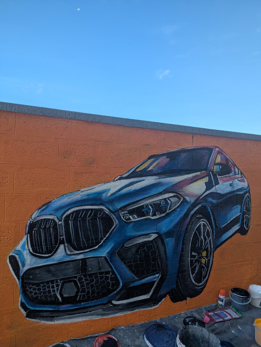 TickDab's tweet image. Blue beast on brick canvas.
A vibrant BMW mural that turns an orange wall into a street level showroom.
#artist #carpainting