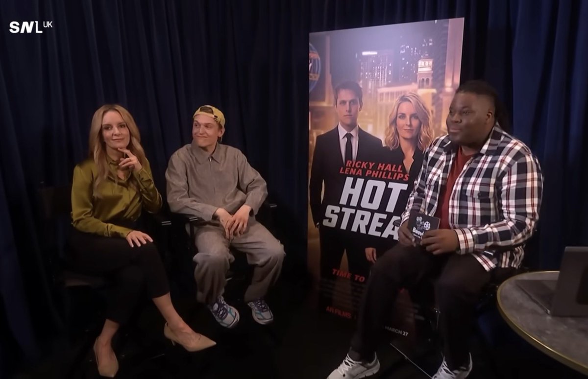 The poster for the film from the interview skit is in the background 😭 #SNLUK