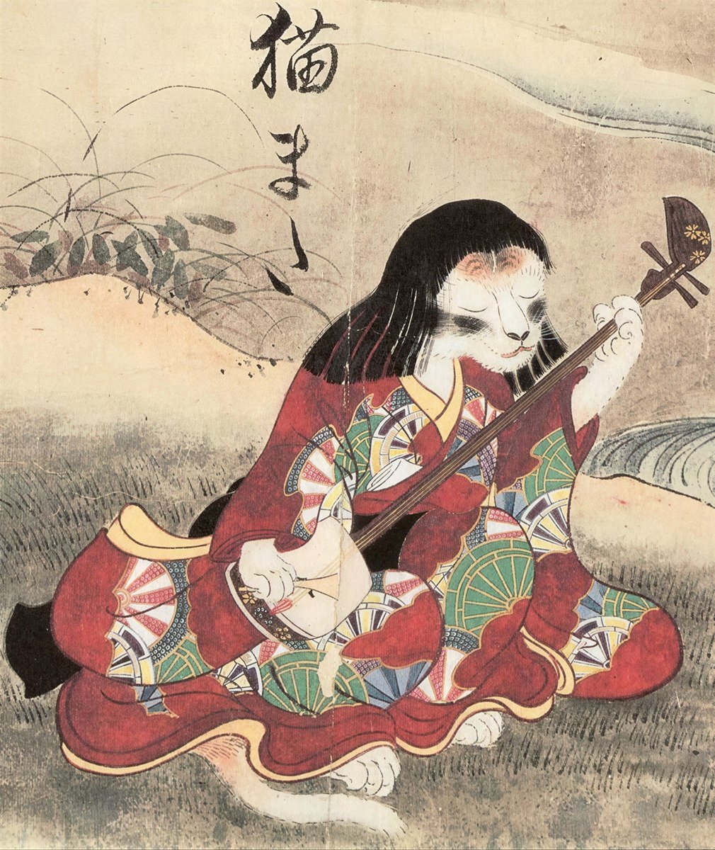 archaeologyart's tweet photo. An elegant figure wearing a red kimono, her eyes closed, peacefully playing music. But this isn't a human. As the calligraphy in the top-left corner clearly declares: This is the Nekomata (猫又) -Japan's most mysterious cat yōkai.

So, what's a yōkai? Yōkai (妖怪): the general term for supernatural beings in Japanese folklore. Not ghosts. Not demons, either. Think of them more like this: something ordinary -an animal, an object, or even an emotion- transforms over time and acquires extraordinary powers. Yōkai are these transformed beings dwelling in the invisible layer of the world.

The cat yōkai is born from exactly this logic: a cat lives a very long time, and its tail splits in two. This split symbolizes an ordinary animal's transition into a yōkai. It's now stepped outside the laws of nature. Its name comes from this physical change: Neko = cat, mata = forked - - - Nekomata (猫又).

Sawaki Suushi painted this in 1737. He was a student of the master painter Hanabusa Itchō. He didn't achieve great fame in his own era - but the scroll he left behind contains 30 yōkai and became one of the cornerstones of Japanese iconography. Pay attention to the figure: long dark hair, a white cat face bearing pale spots on its forehead, and a layered, flamboyant red kimono. And from beneath her skirt, that famous white tail curls out.

Cat, or woman? Both. And that's exactly the dangerous part. The instrument in her hands: the Shamisen.

A traditional three-stringed, long-necked Japanese instrument - still played today, with a timbre somewhat reminiscent of a banjo. Traditional shamisen bodies were mostly covered with cat skin (while the strings were made of silk). The Nekomata is playing an instrument whose body is made from the skin of her own kind. Both victim and musician. The cycle is complete.

An Edo-period viewer would've understood this immediately: this isn't a portrait of a beauty. This is the depiction of a hidden rage. According to folklore, the Nekomata:

Can haunt the living by making them dance like puppets..Can control the dead,Can summon ghosts,
It was believed that abandoned old cats transformed into them. A rage returning as a curse. But Suushi drew the figure neither aggressive nor ugly. Calm. Elegant. Peaceful. This is a deliberate choice ,- and much more effective. It's more unsettling precisely because it looks familiar.Suushi's scroll became a major point of reference. In 1776, Toriyama Sekien drew heavy inspiration from this scroll for his yōkai depictions in the famous Gazu Hyakki Yagyō series.

Today, this scroll is housed in the Fukuoka City Museum. That cat figure playing the shamisen has been asking the same question since 1737:What does the one who abandoned me deserve? Perhaps music. Perhaps more..