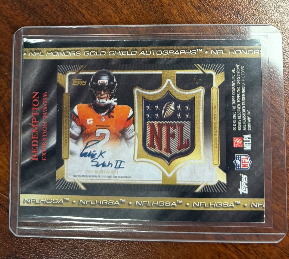 Topps's tweet photo. JUST PULLED: 1-of-1 Pat Surtain II Gold NFL Shield autograph 🤯

(via Luckbox Sports Cards) https://t.co/aXVJ2XUQxe