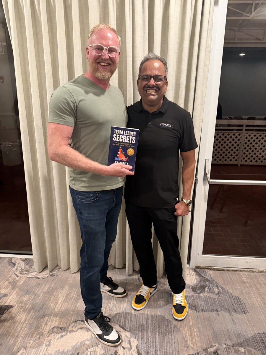 FriendinRealty's tweet photo. Sunset, a curtain backdrop, and a guy handing me his book with both hands. Team Leader Secrets by Suneet. He didn't write a theory book. He wrote what he actually built. Those are the only ones worth reading. https://t.co/PYezHRW5OU