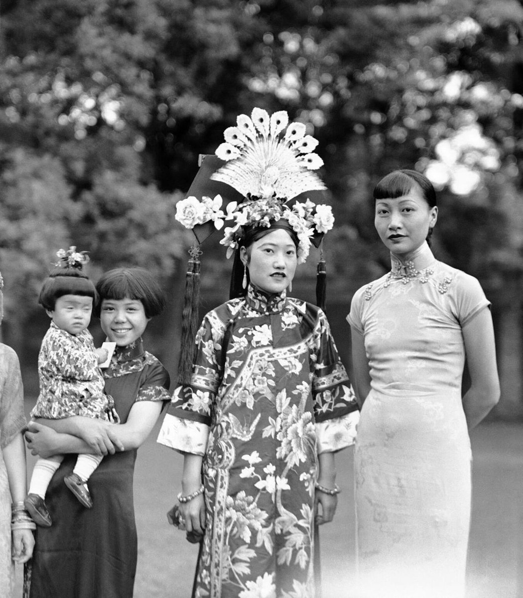 Anna May Wong (right), well-known Chinese-American film star, visiting Beijing on August 25, 1936,  with the adopted Chinese daughters of Miss Helen Burton, prominent North Dakotan woman, who is engaged in the antique business in the city,  AP Photo.
