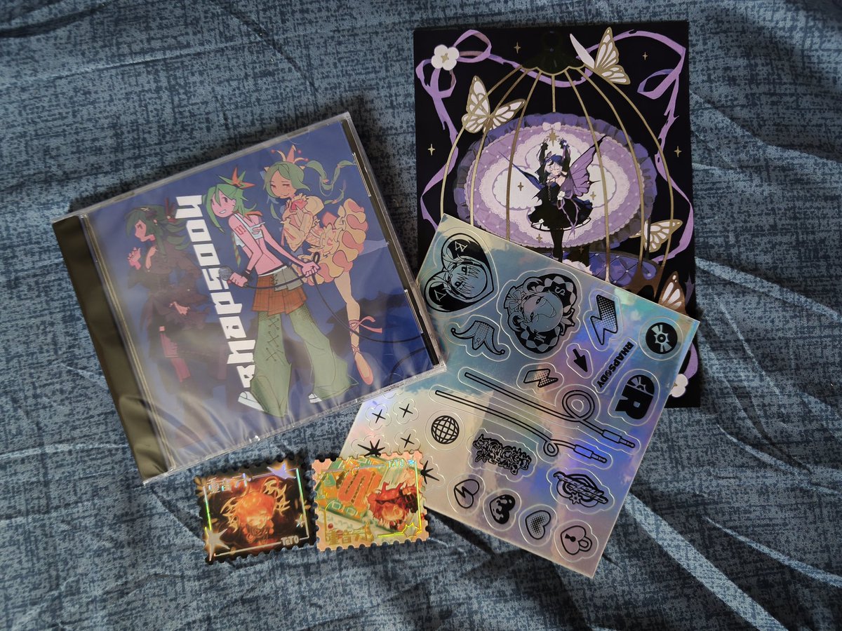 Got my <a href="/vocaloidmerch/">Rhapsody: A Vocaloid Merch Box 🎙️ PRODUCTION</a> Rhapsody CD today! 🤩