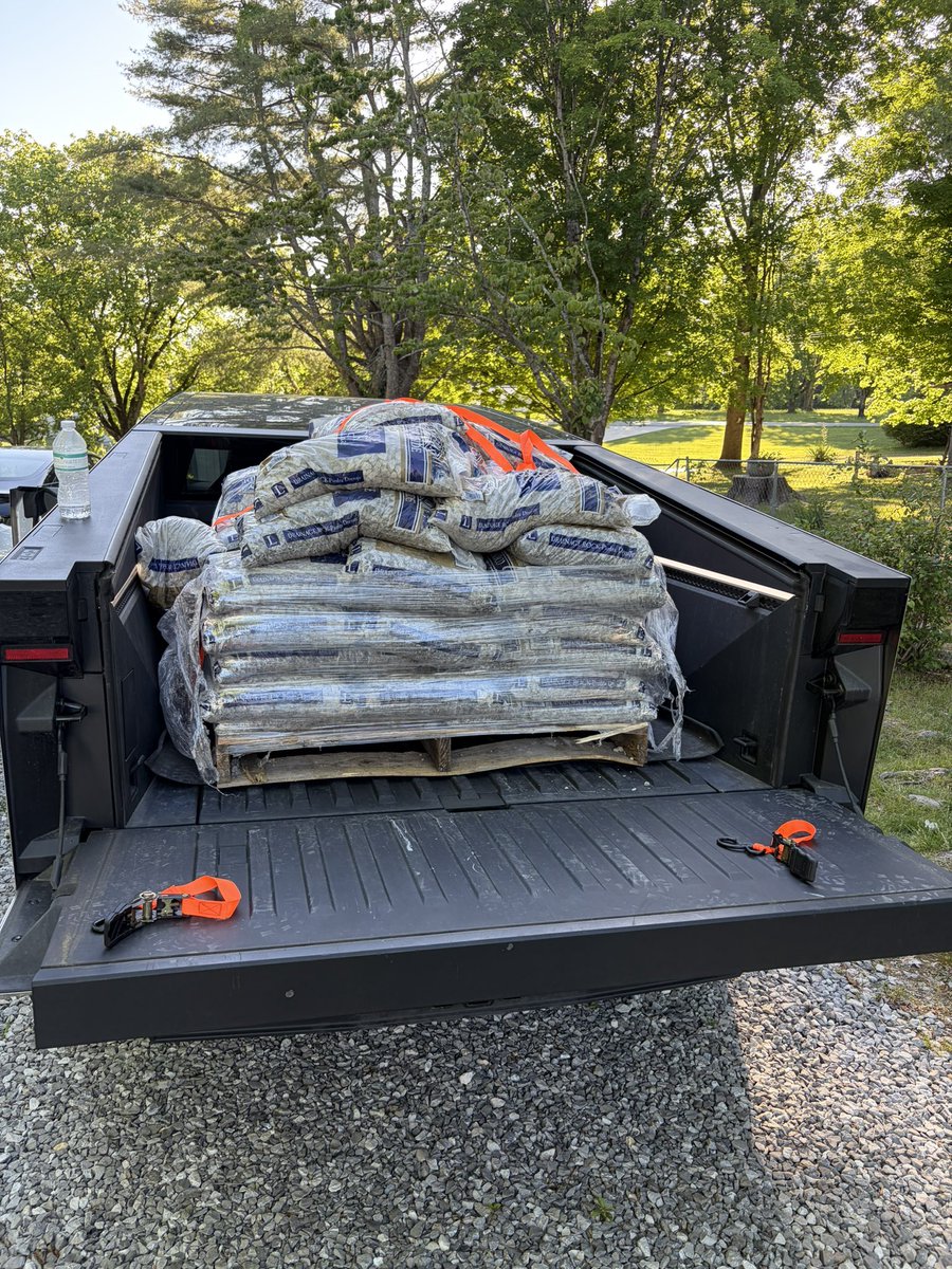 Austinlee86's tweet photo. Maxed out 📐 payload capacity with 2500 lbs of rock. Crossed the recommended limit 😅 but the truck did just fine for this short trip. At first, the truck sagged greatly, then the air suspension kicked in and you couldn’t even tell it had a load in the back. Love this truck! https://t.co/1SySrv4zEL