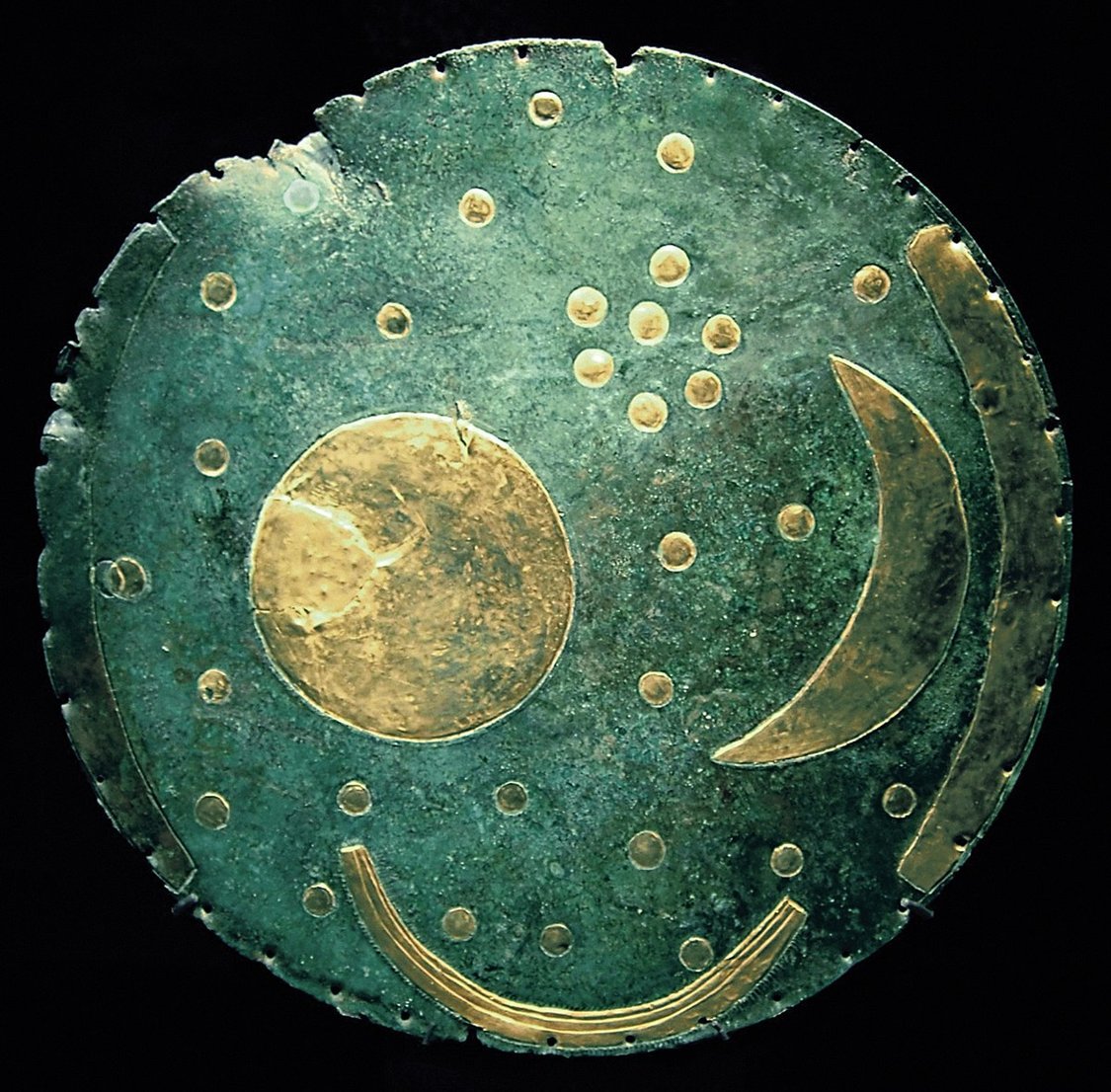 3600-year-old, the Nebra Sky Disc. the oldest depiction of the cosmos in the world; showing the sun, moon and several other celestial constellations.

Found in a burial in Saxony - Germany. Dated to 1600 BC